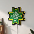 Unlit Selamat Idulfitri LED lightbox mounted on a wall in daylight