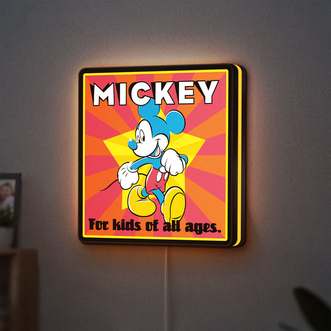 Mickey Mouse LED lightbox hanging on a wall with yellow glow