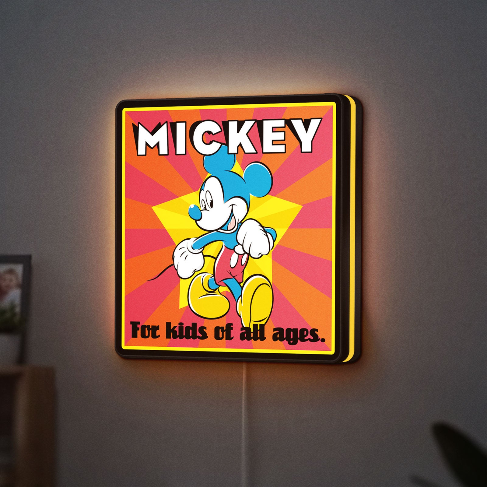 Mickey Mouse LED lightbox hanging on a wall with yellow glow