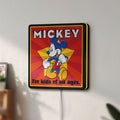 Unlit Mickey Mouse LED lightbox mounted on a wall in daylight