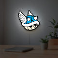Blue Shell LED lightbox hanging on a room wall with soft white light