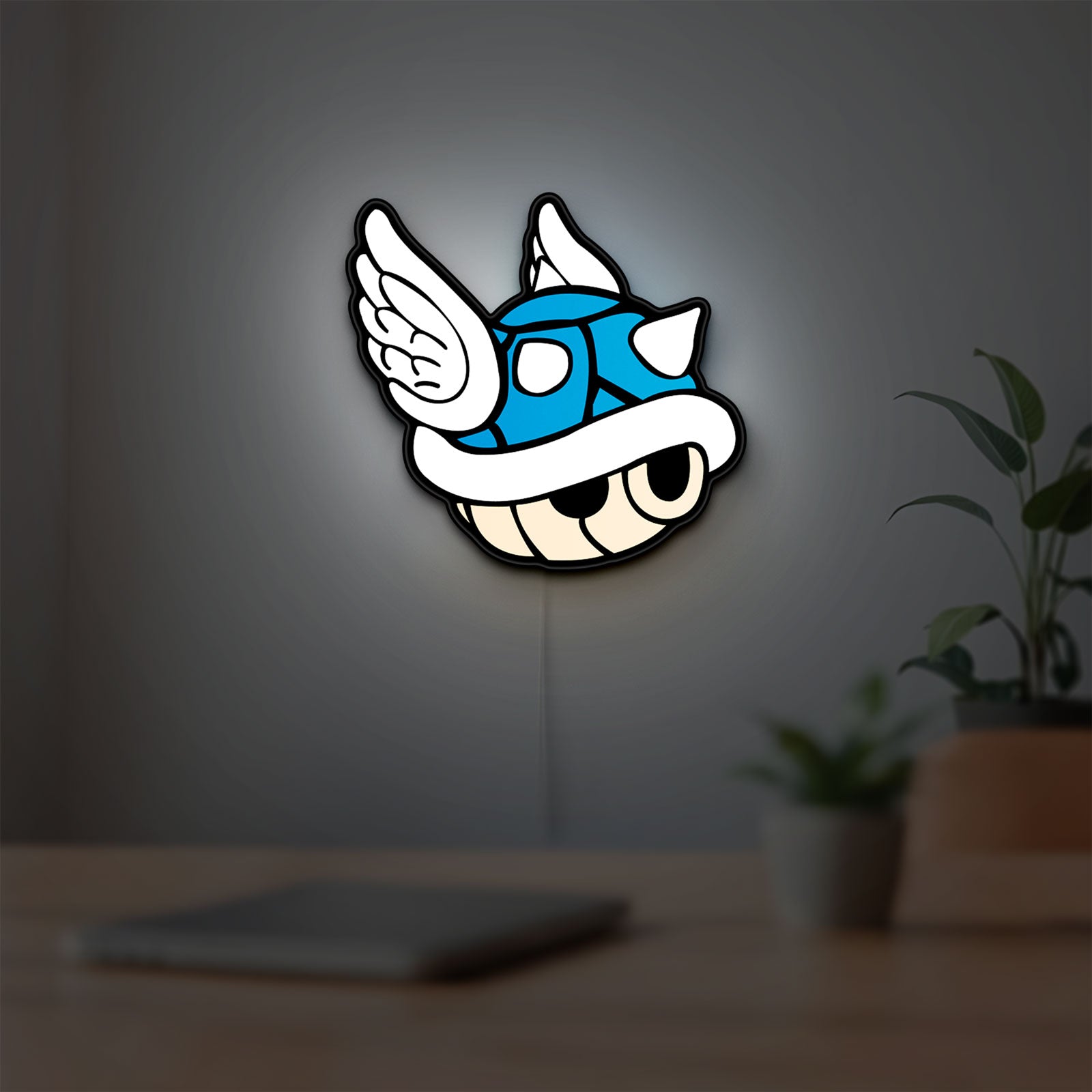 Blue Shell LED lightbox hanging on a room wall with soft white light