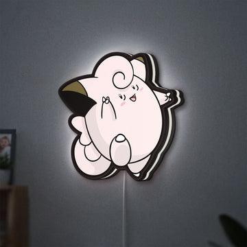 Clefairy LED lightbox hanging on a wall with white glow