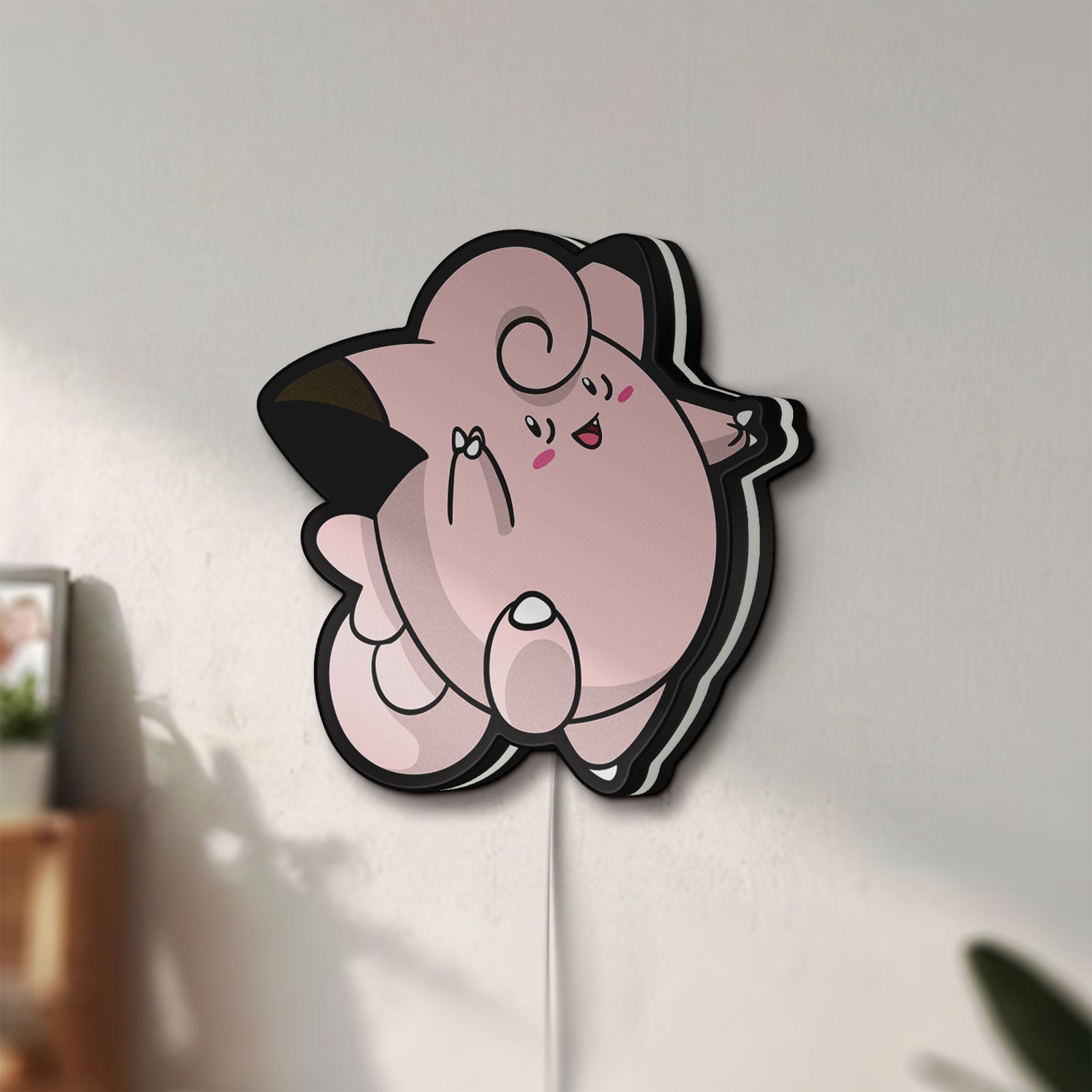 Unlit Clefairy LED lightbox mounted on a wall in daylight