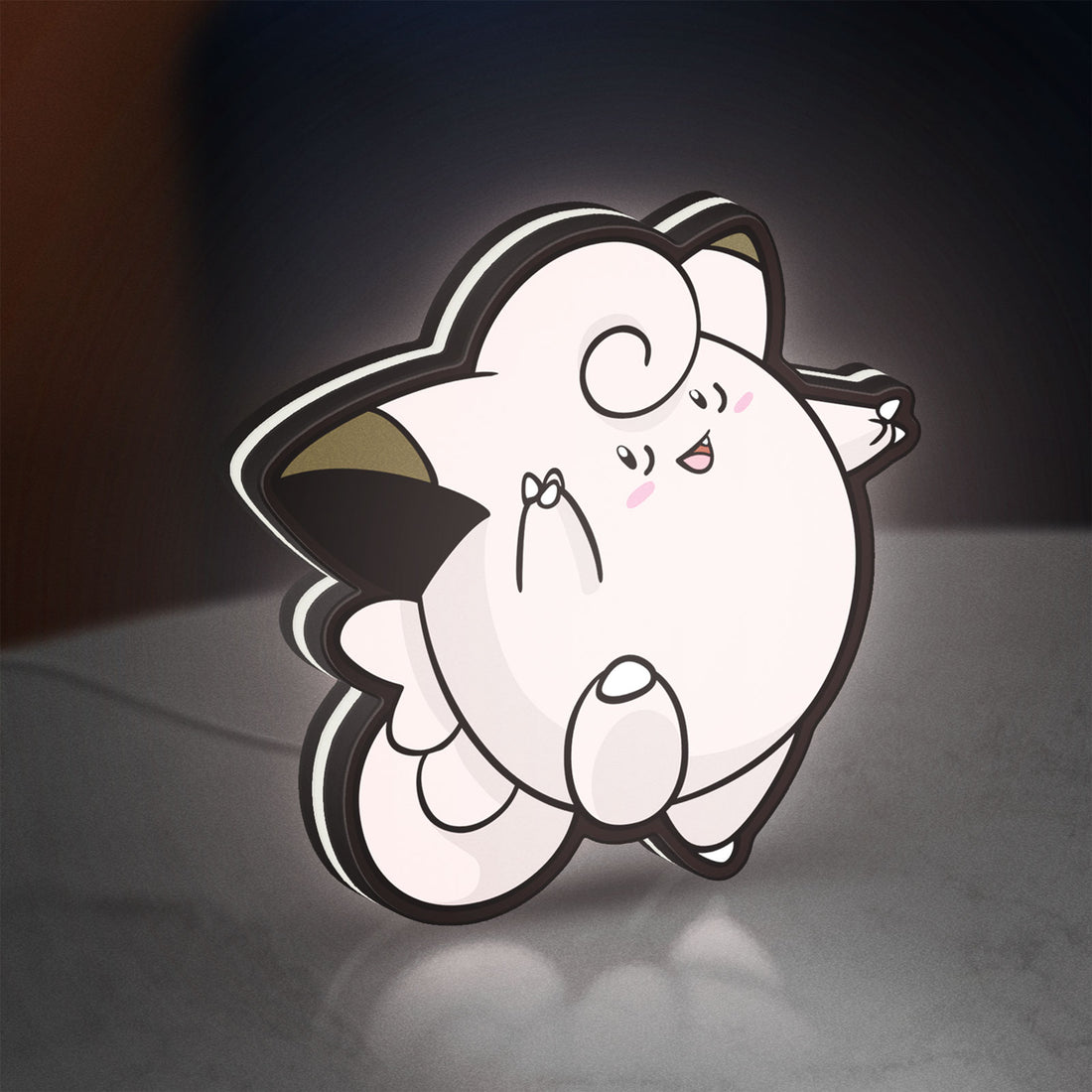 Clefairy LED lightbox hanging on a wall with white glow