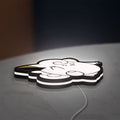 Clefairy LED lightbox lying flat on a desk with white glow