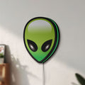 Unlit Alien LED lightbox mounted on a wall in daylight