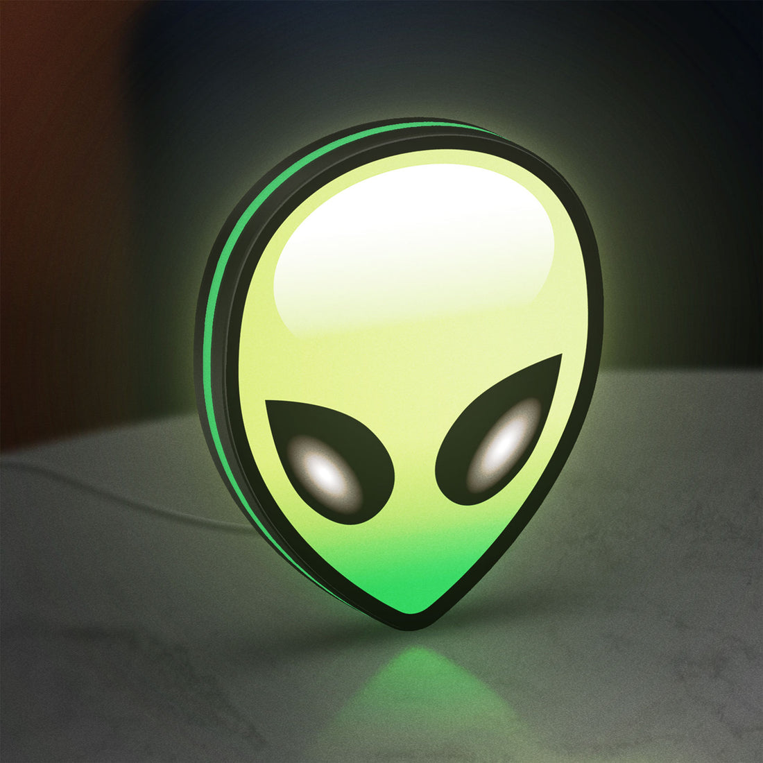 Alien LED lightbox hanging on a wall with green glow
