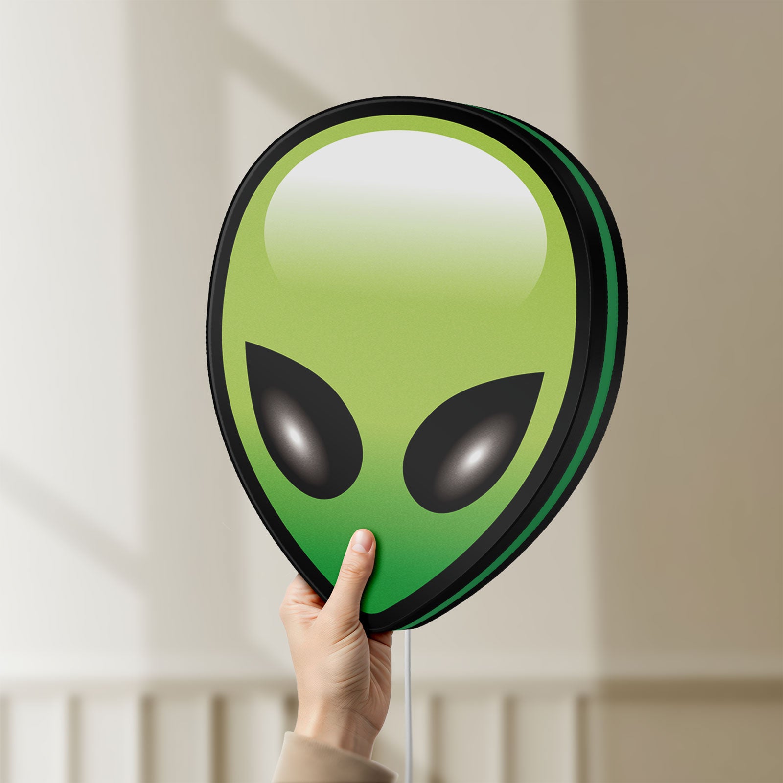 Unlit Alien LED lightbox held by hand to show size and details