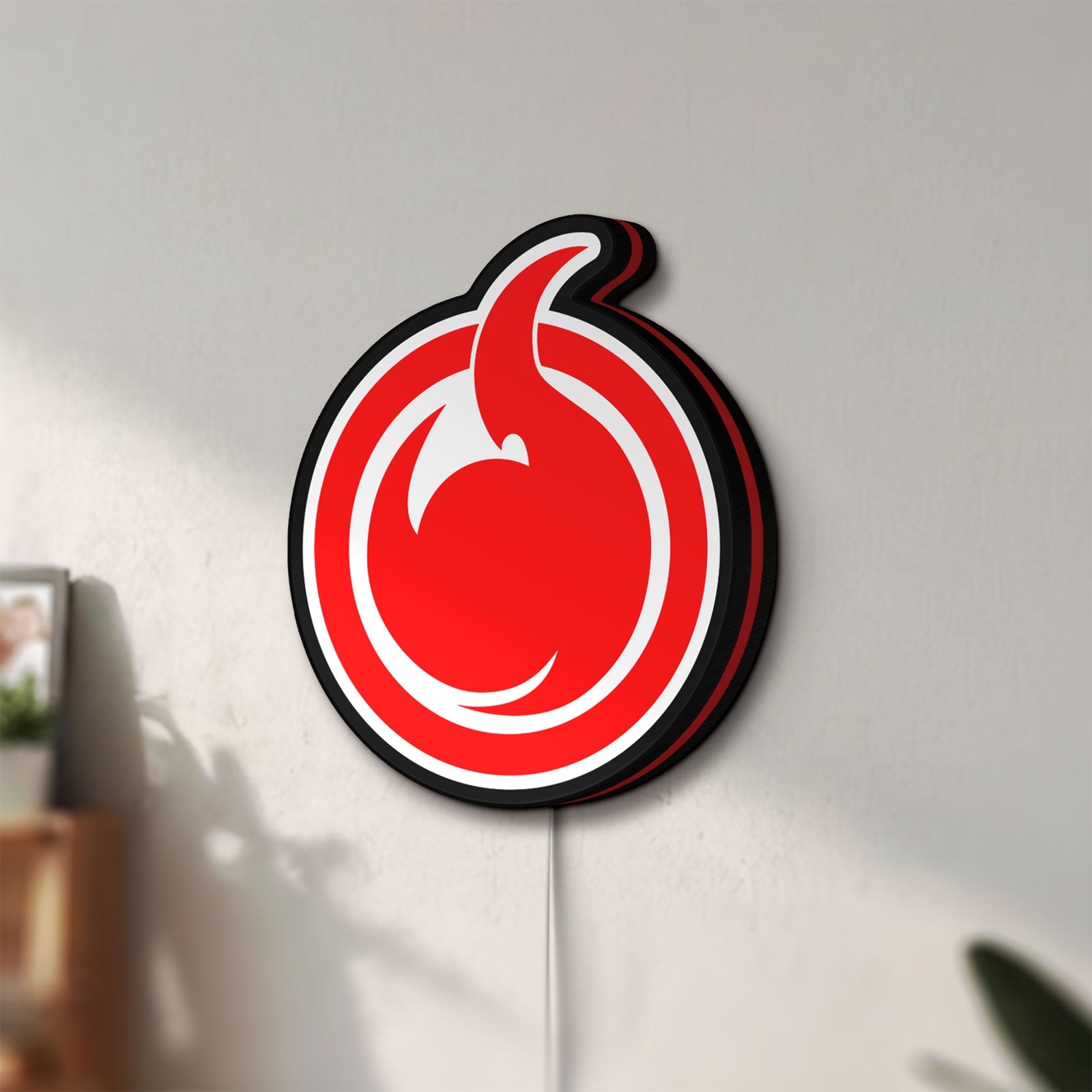 Unlit Hell Girl Fire Symbol LED lightbox mounted on a wall in daylight