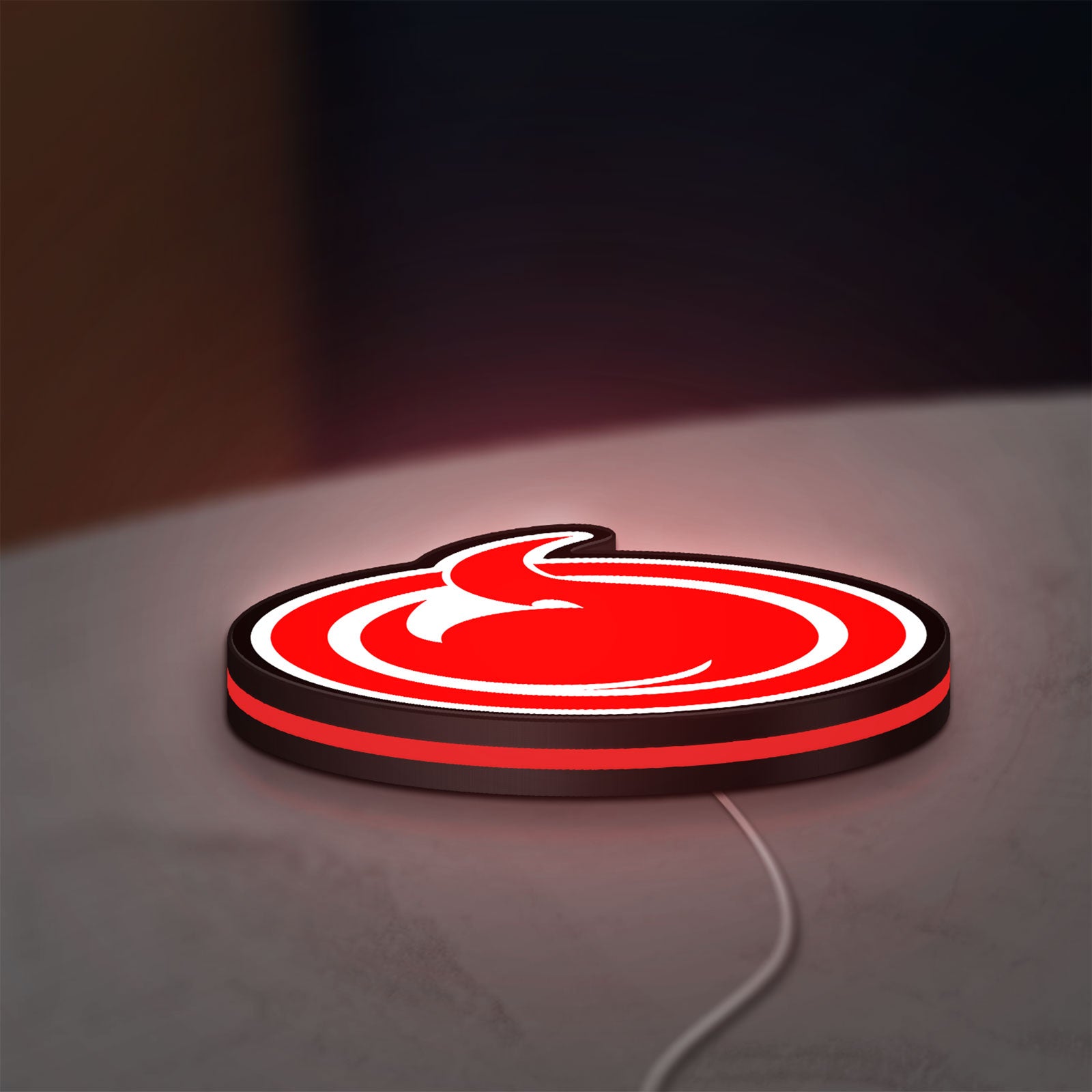 Hell Girl Fire Symbol LED lightbox lying flat on a desk with red glow