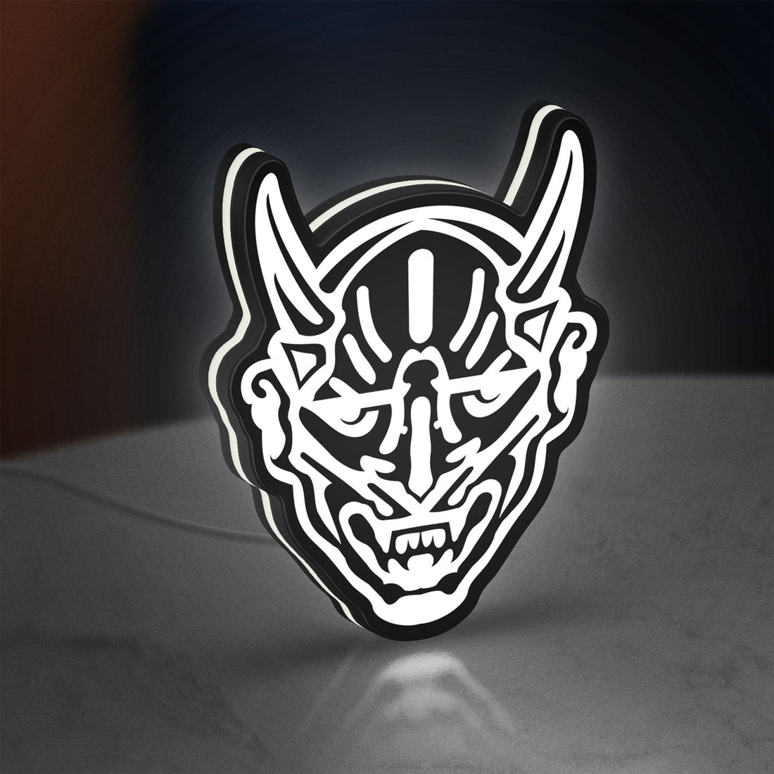 Japanese Hannya Mask LED lightbox hanging on a wall with white glow