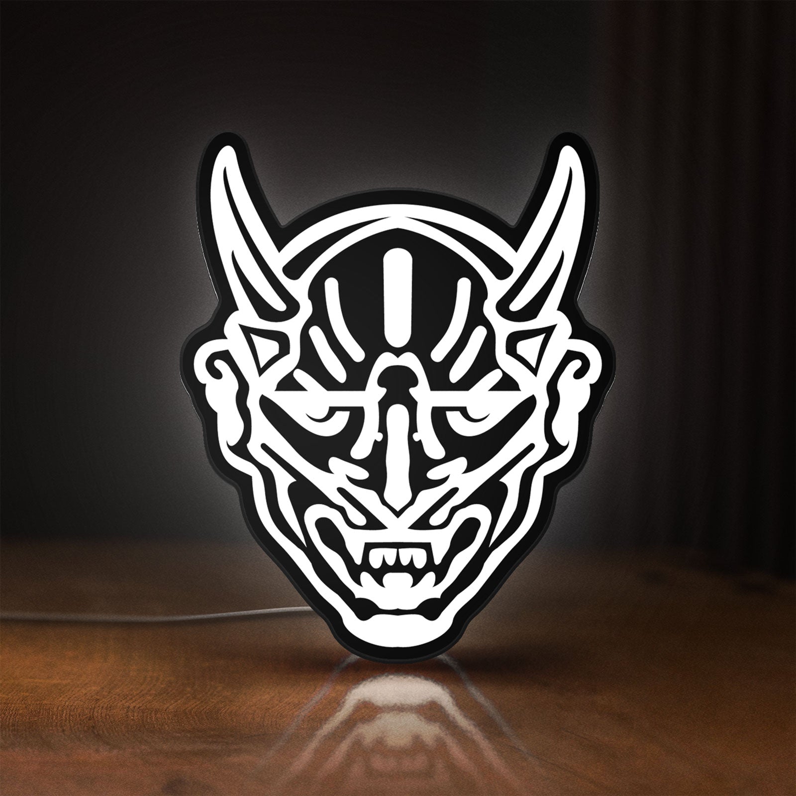 Front view of Japanese Hannya Mask LED lightbox sign glowing on a wooden desk