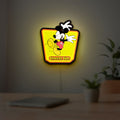 Mickey Mouse LED lightbox hanging on a room wall with soft yellow light