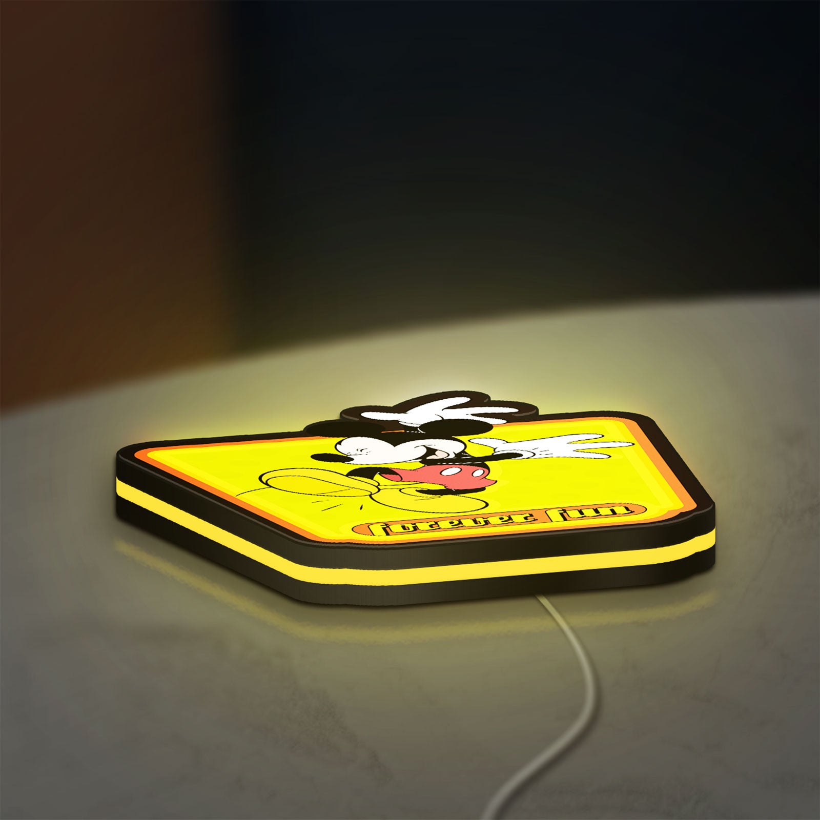 Mickey Mouse LED lightbox lying flat on a desk with yellow glow