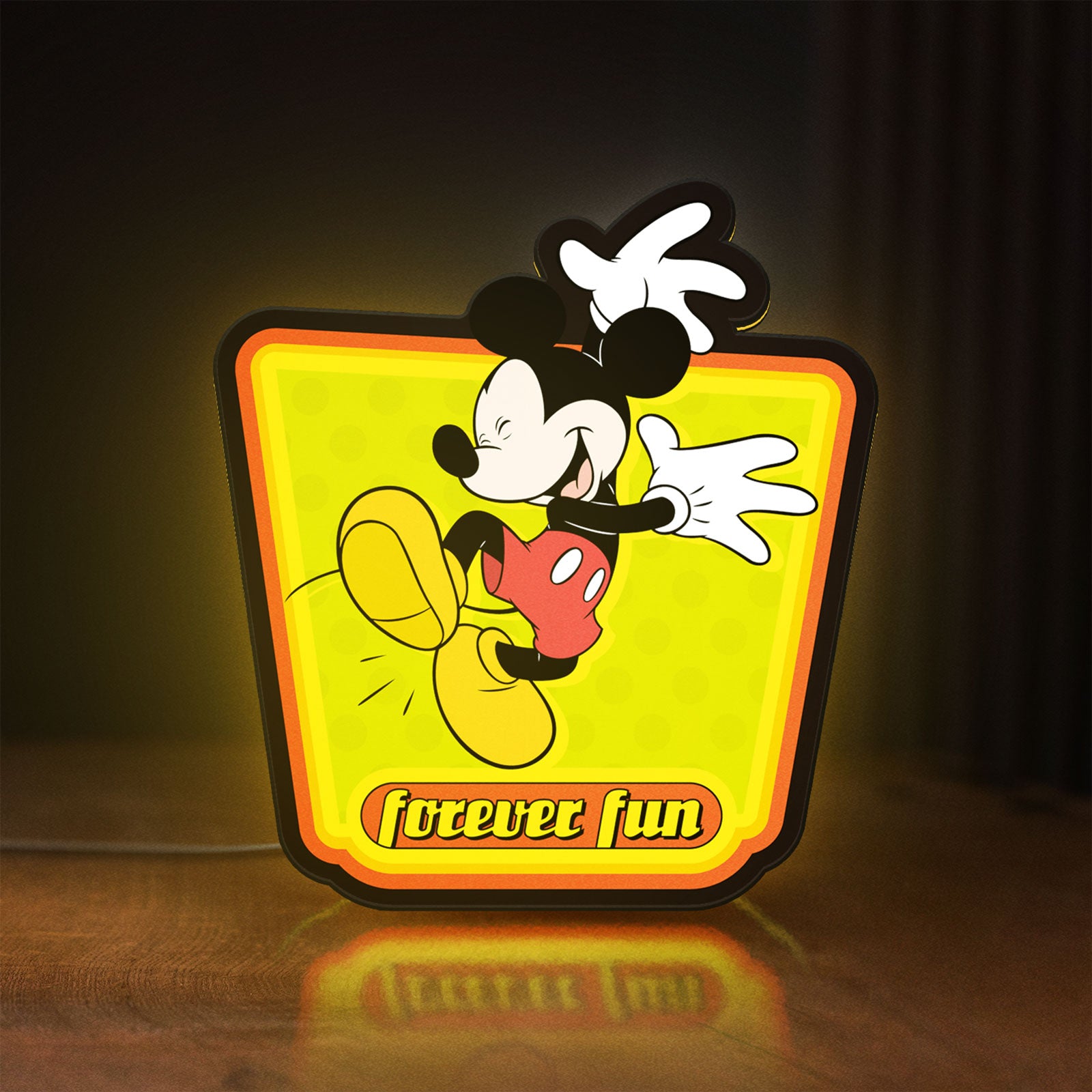 Front view of Mickey Mouse LED lightbox sign glowing on a wooden desk