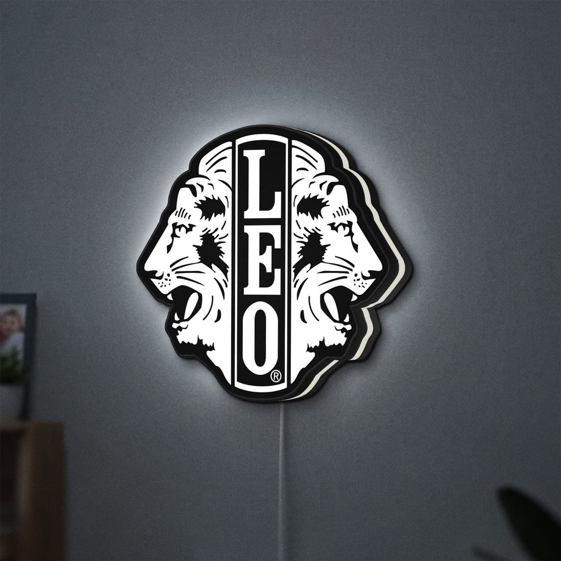 Leo Lion Zodiac LED lightbox hanging on a wall with white glow