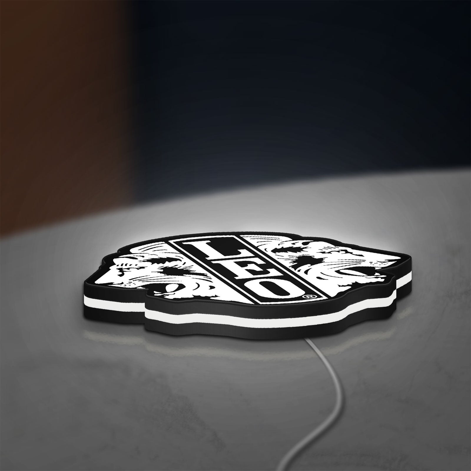 Leo Lion Zodiac LED lightbox lying flat on a desk with white glow