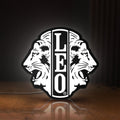 Front view of Leo Lion Zodiac LED lightbox sign glowing on a wooden desk