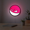 Voltorb LED lightbox hanging on a room wall with soft white light