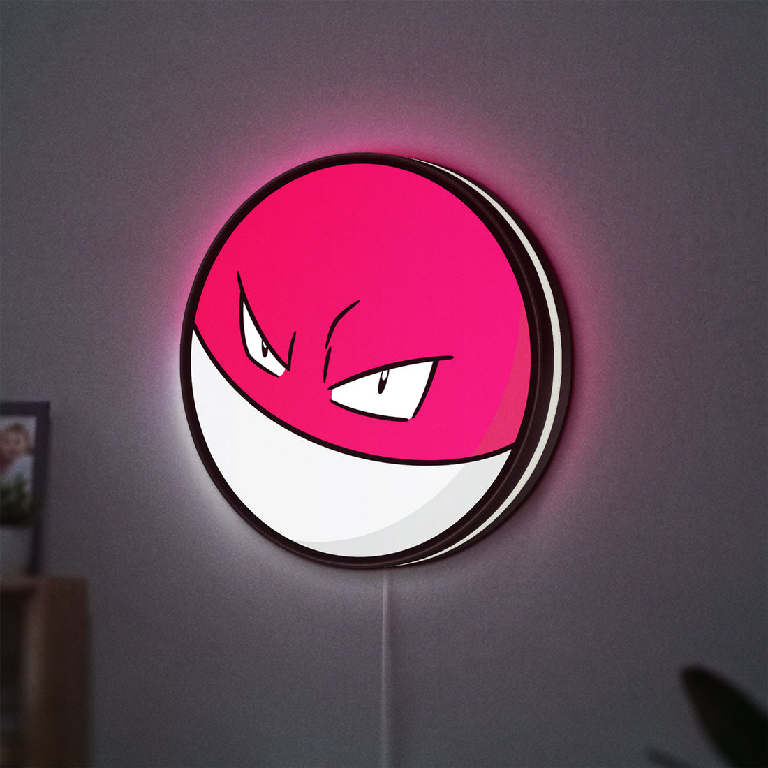Voltorb LED lightbox hanging on a wall with white glow