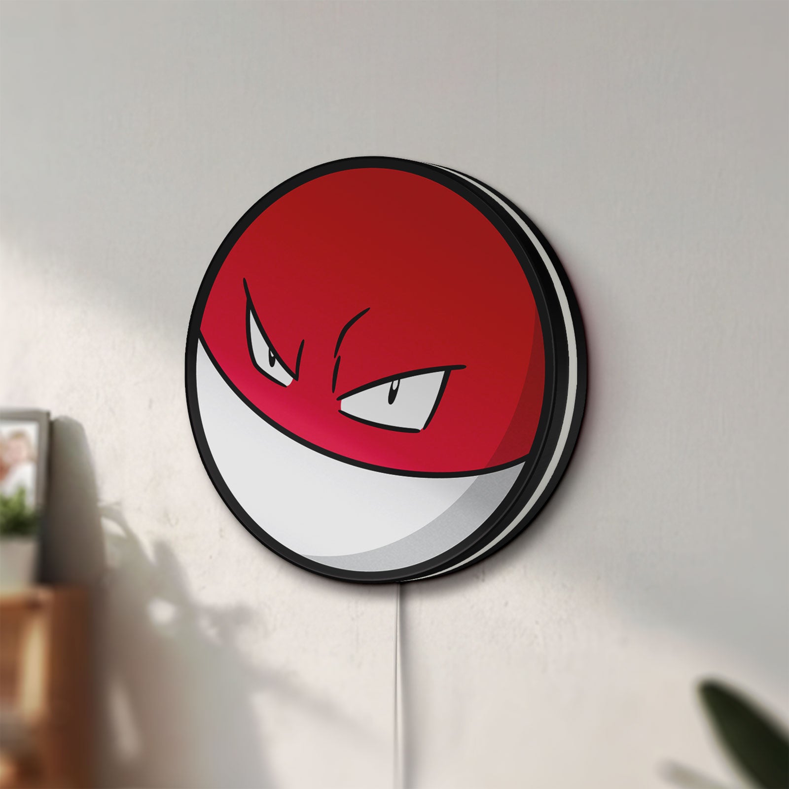 Unlit Voltorb LED lightbox mounted on a wall in daylight