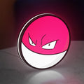 Voltorb LED lightbox standing on a desk from an angled side view with white glow