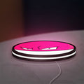 Voltorb LED lightbox lying flat on a desk with white glow
