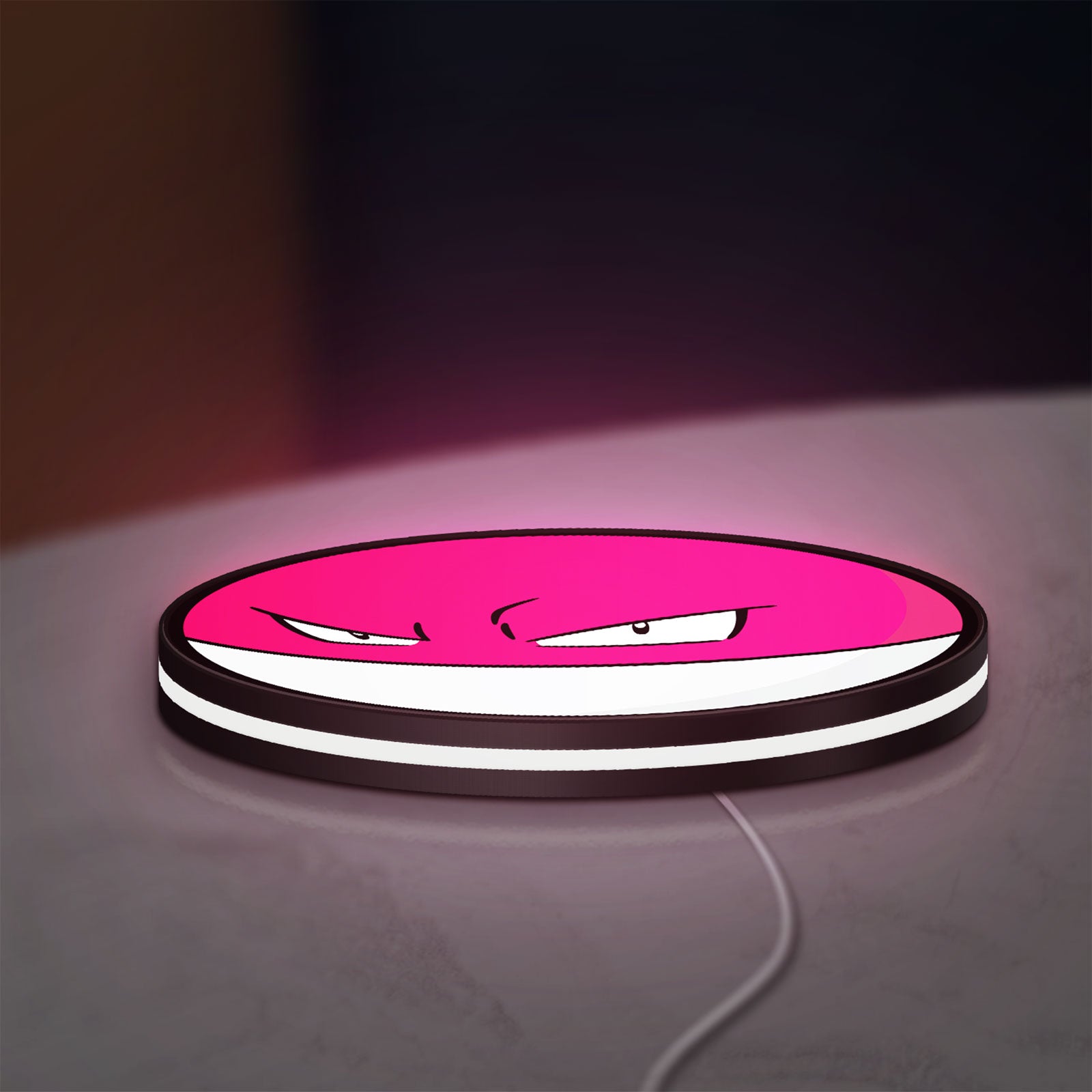 Voltorb LED lightbox lying flat on a desk with white glow