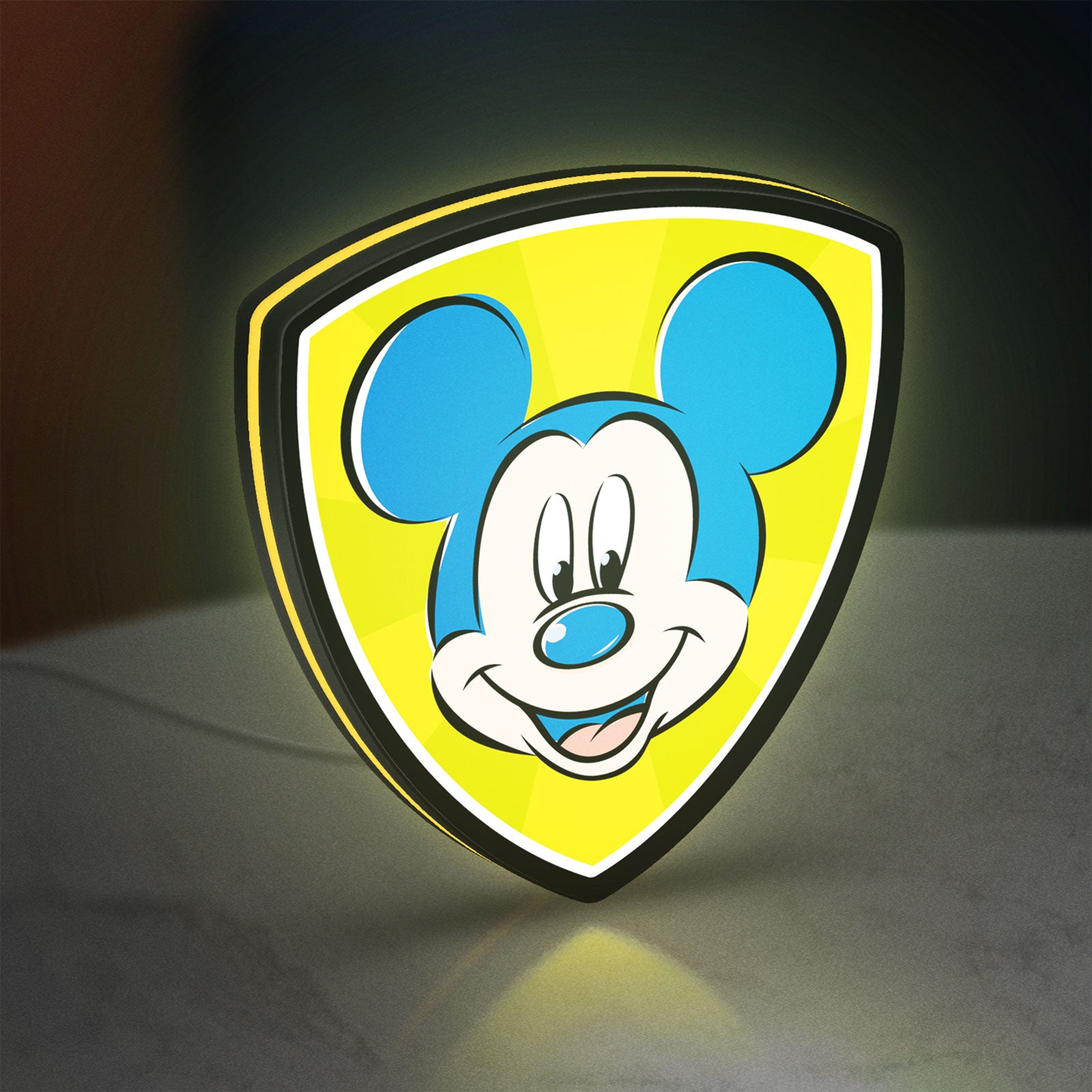Mickey Mouse LED lightbox standing on a desk from an angled side view with yellow glow