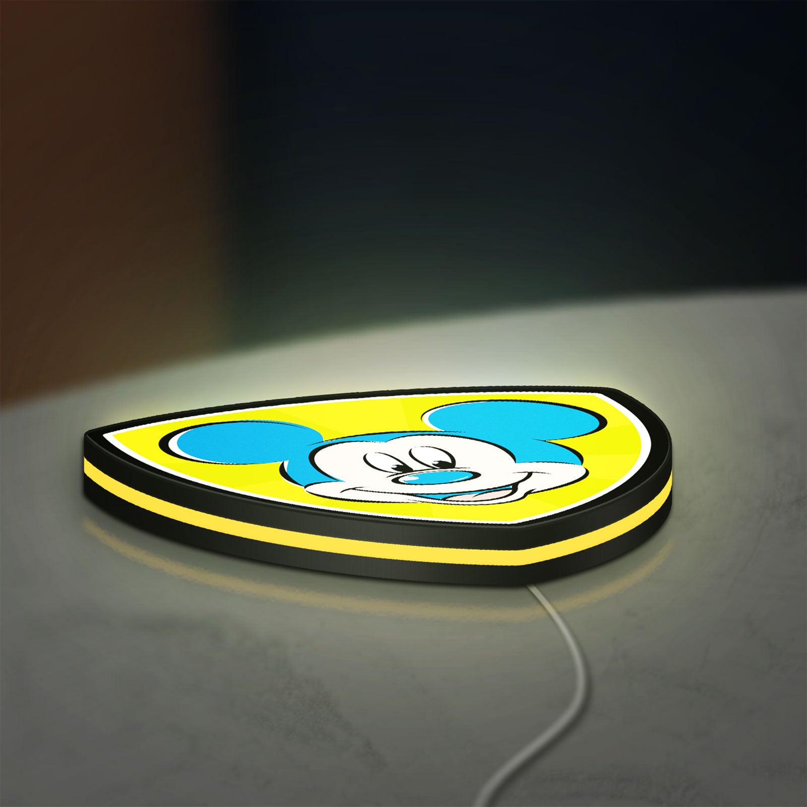 Mickey Mouse LED lightbox lying flat on a desk with yellow glow