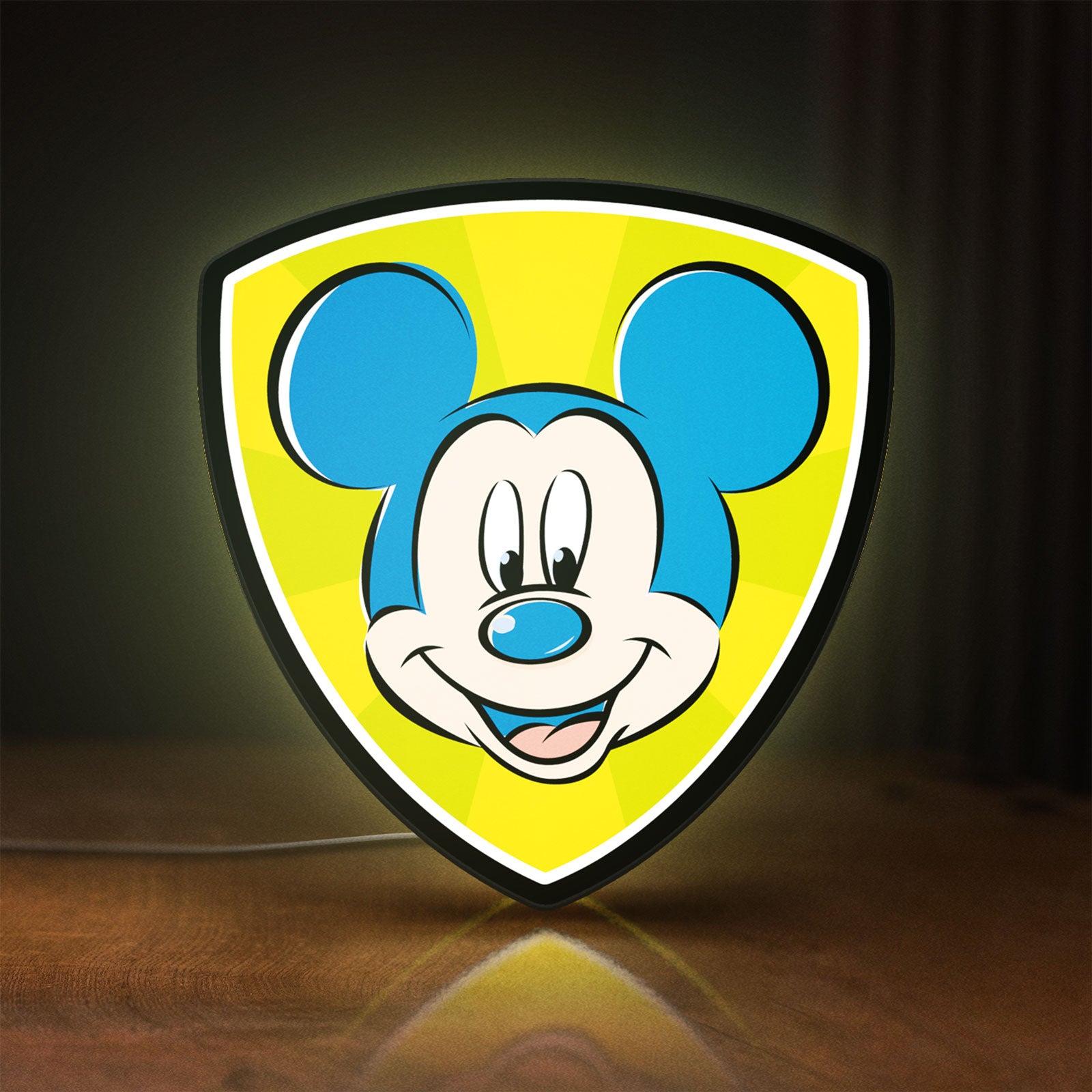 Front view of Mickey Mouse LED lightbox sign glowing on a wooden desk