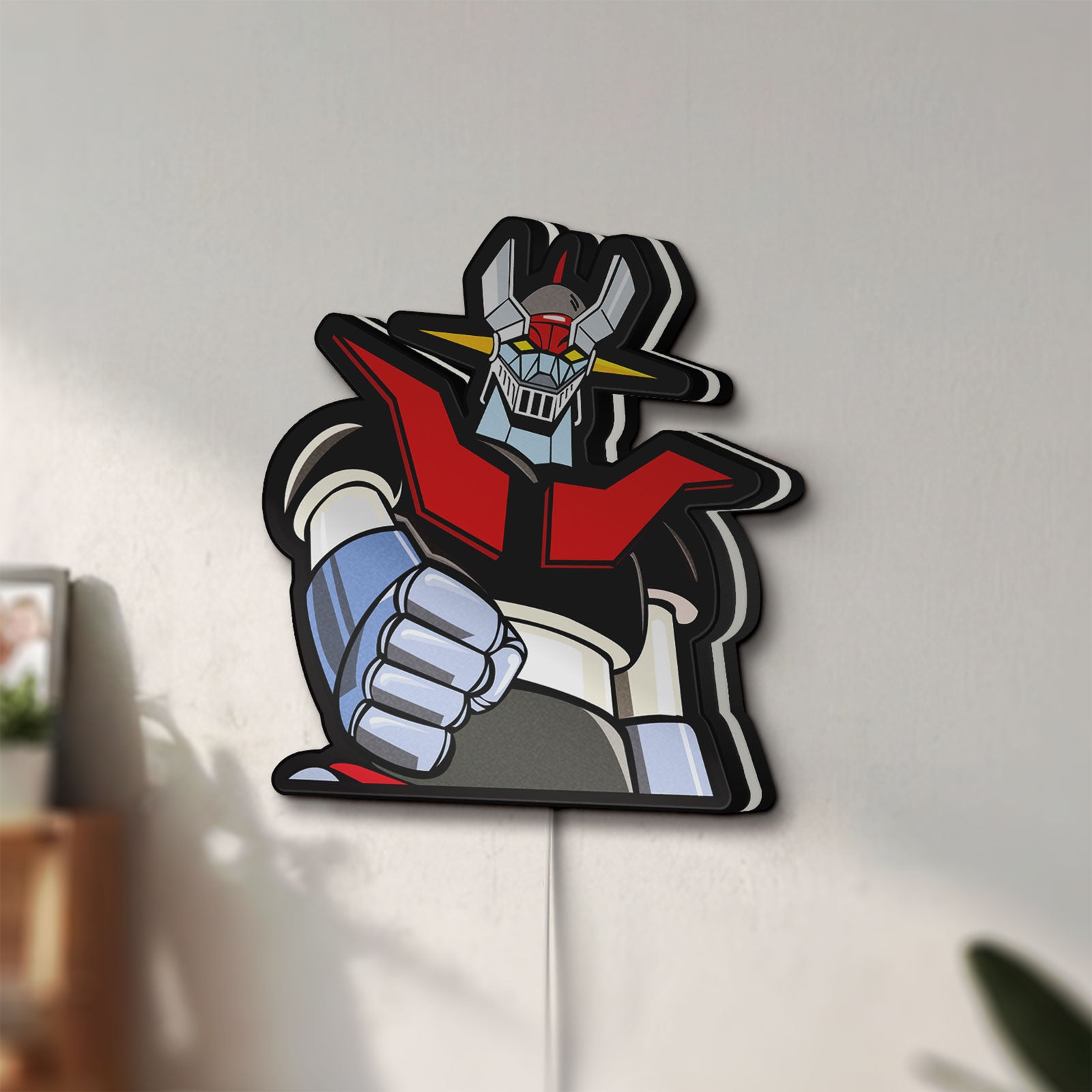 Unlit Mazinger Z LED lightbox mounted on a wall in daylight