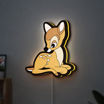 Bambi LED lightbox hanging on a wall with yellow glow