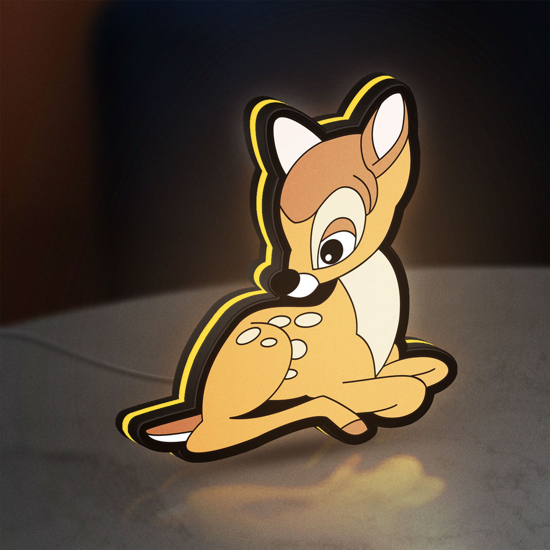 Bambi LED lightbox hanging on a wall with yellow glow