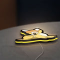 Bambi LED lightbox lying flat on a desk with yellow glow