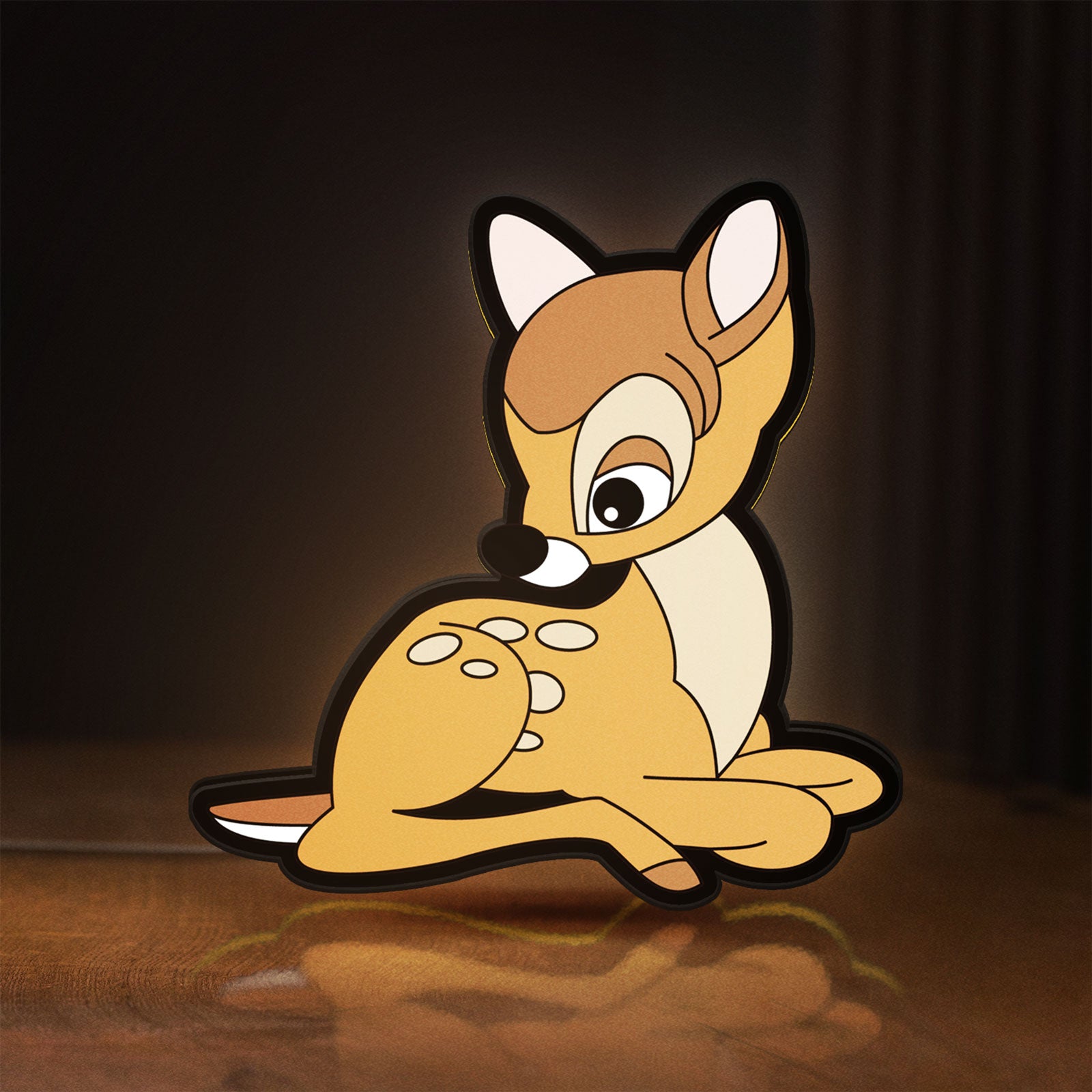 Front view of Bambi LED lightbox sign glowing on a wooden desk