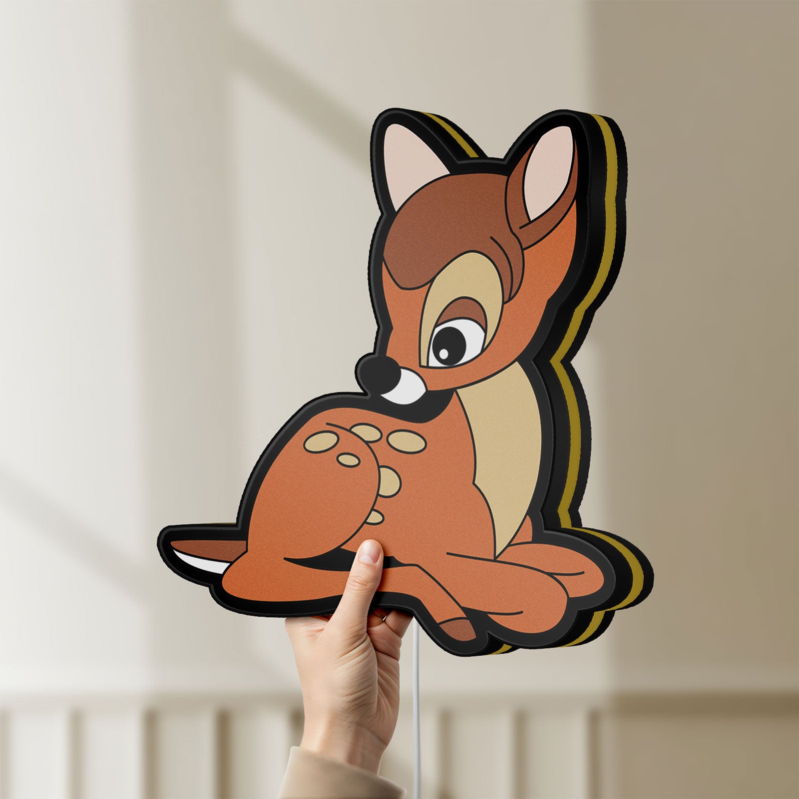 Unlit Bambi LED lightbox held by hand to show size and details