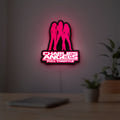 Charlie's Angels LED lightbox hanging on a room wall with soft pink light