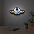 Regal Raptor Motorcycles LED lightbox hanging on a room wall with soft orange light