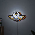 Regal Raptor Motorcycles LED lightbox hanging on a wall with orange glow