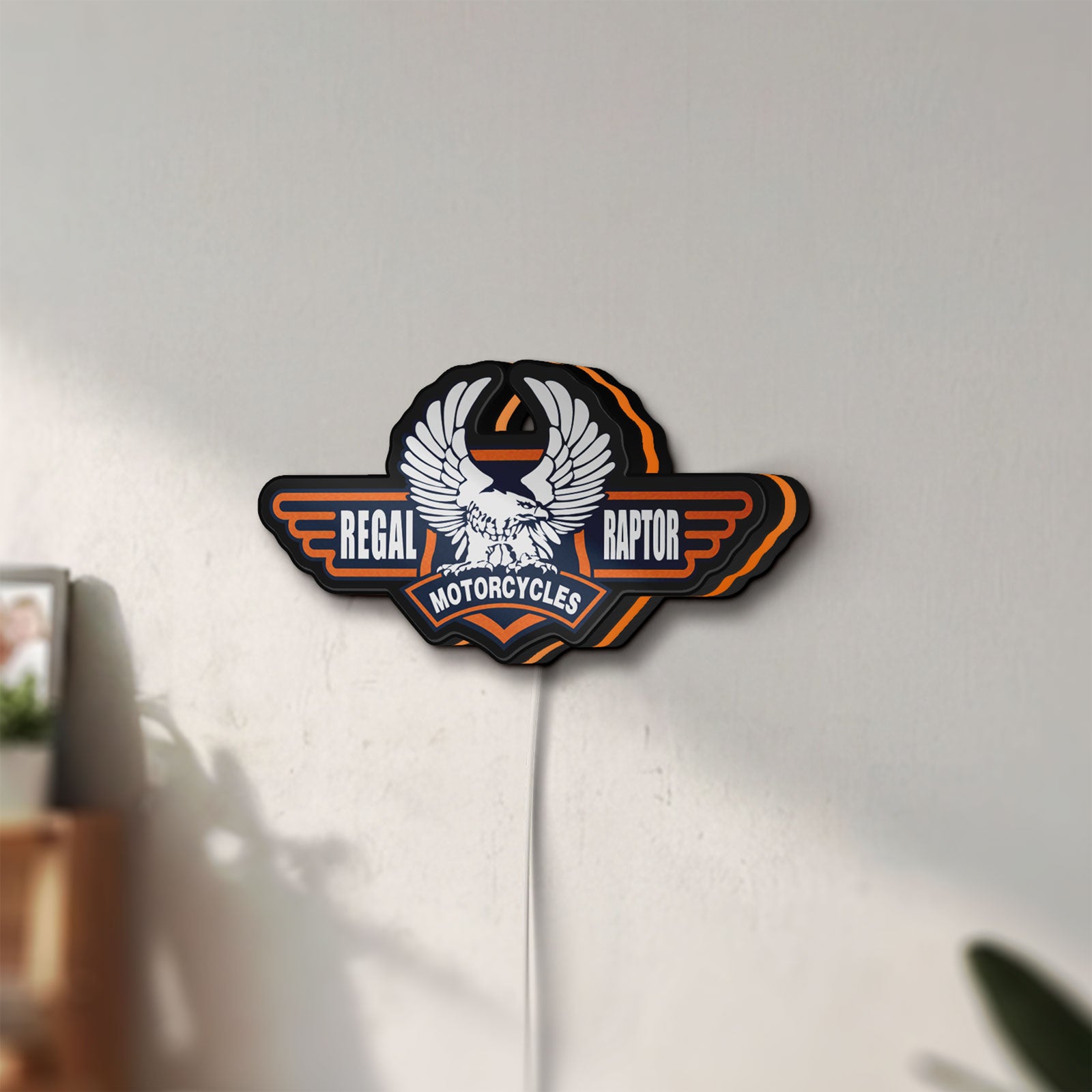Unlit Regal Raptor Motorcycles LED lightbox mounted on a wall in daylight