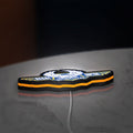 Regal Raptor Motorcycles LED lightbox lying flat on a desk with orange glow