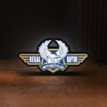 Front view of Regal Raptor Motorcycles LED lightbox sign glowing on a wooden desk