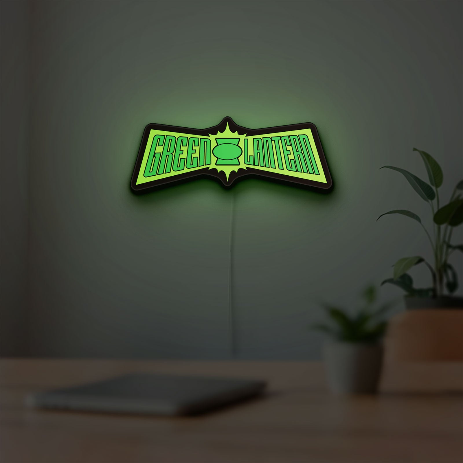 Green Lantern LED lightbox hanging on a room wall with soft green light