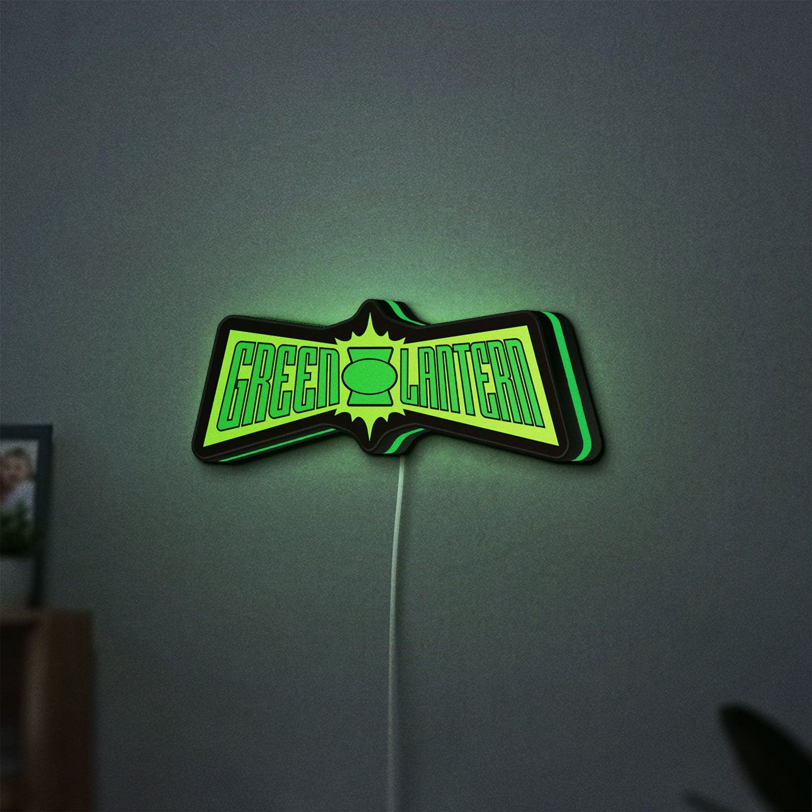 Green Lantern LED lightbox hanging on a wall with green glow