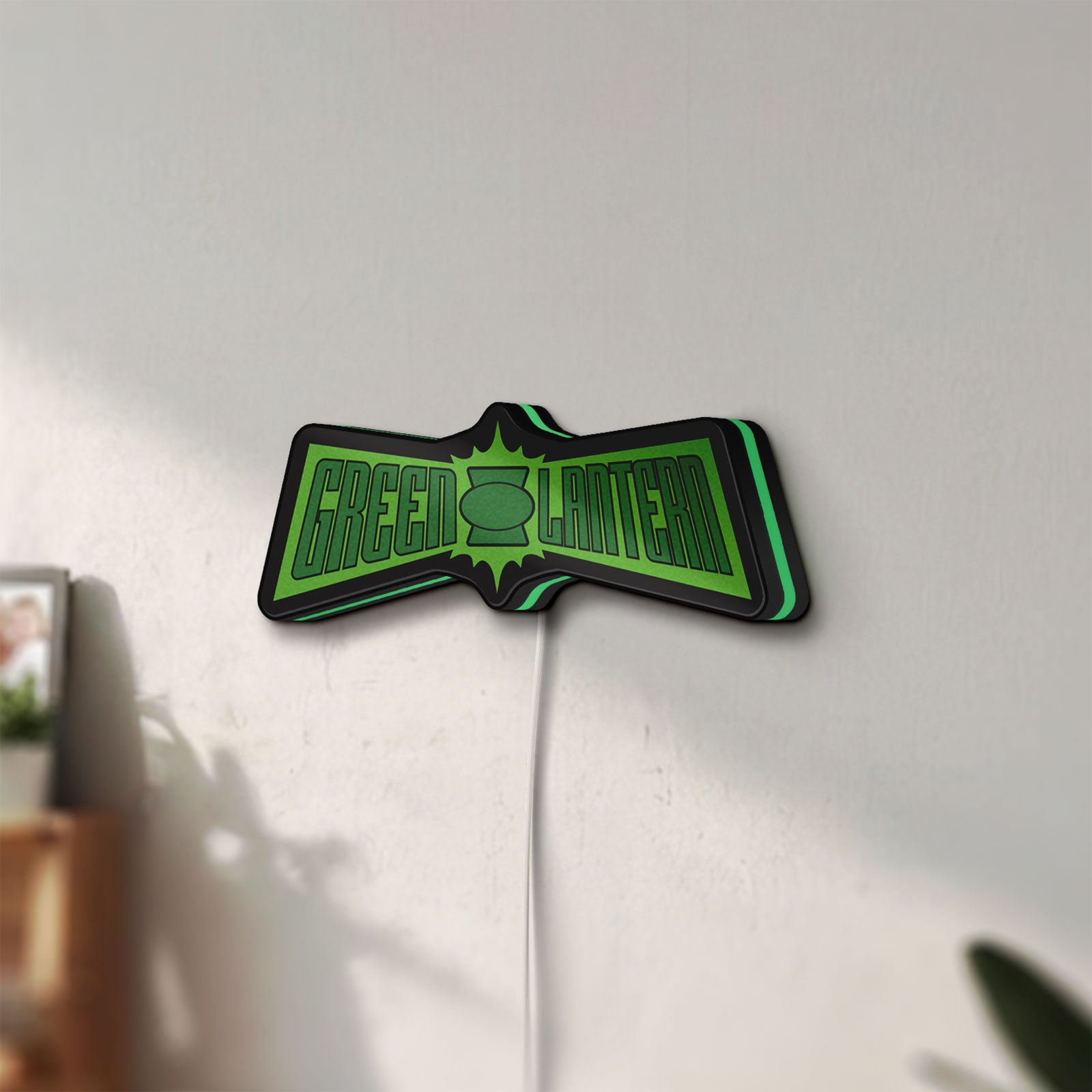 Unlit Green Lantern LED lightbox mounted on a wall in daylight