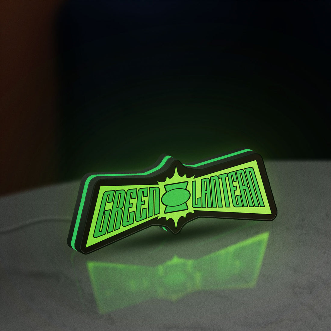 Green Lantern LED lightbox hanging on a wall with green glow