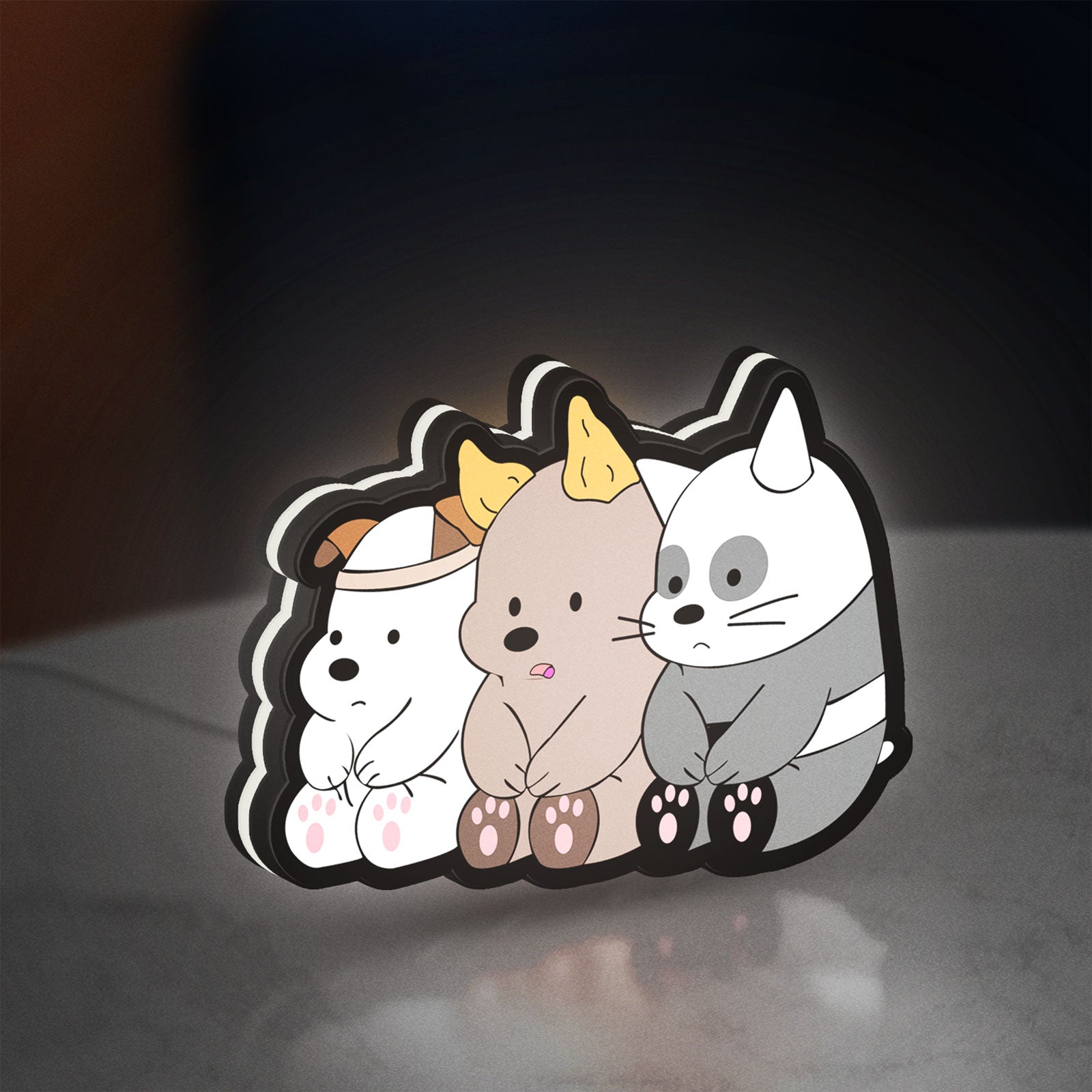 We Bare Bears LED lightbox standing on a desk from an angled side view with white glow