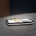 We Bare Bears LED lightbox lying flat on a desk with white glow